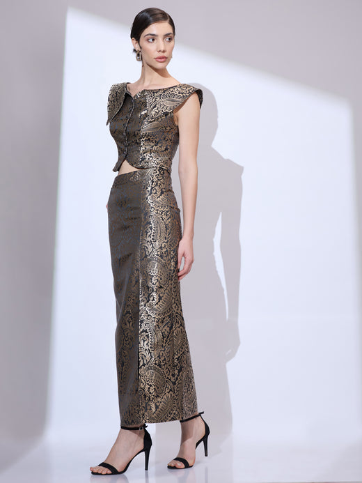 Woman walking left and looking right wearing a black and gold metallic paisley formal co-ord set for women with cropped top and maxi skirt