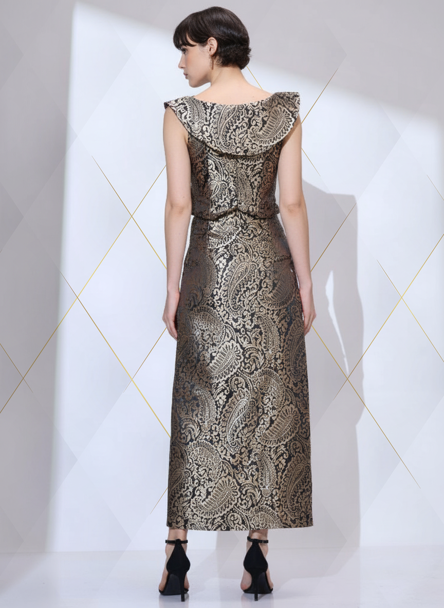 Back view of woman wearing a black and gold metallic paisley brocade co ord set with cropped top and floor-length pencil skirt