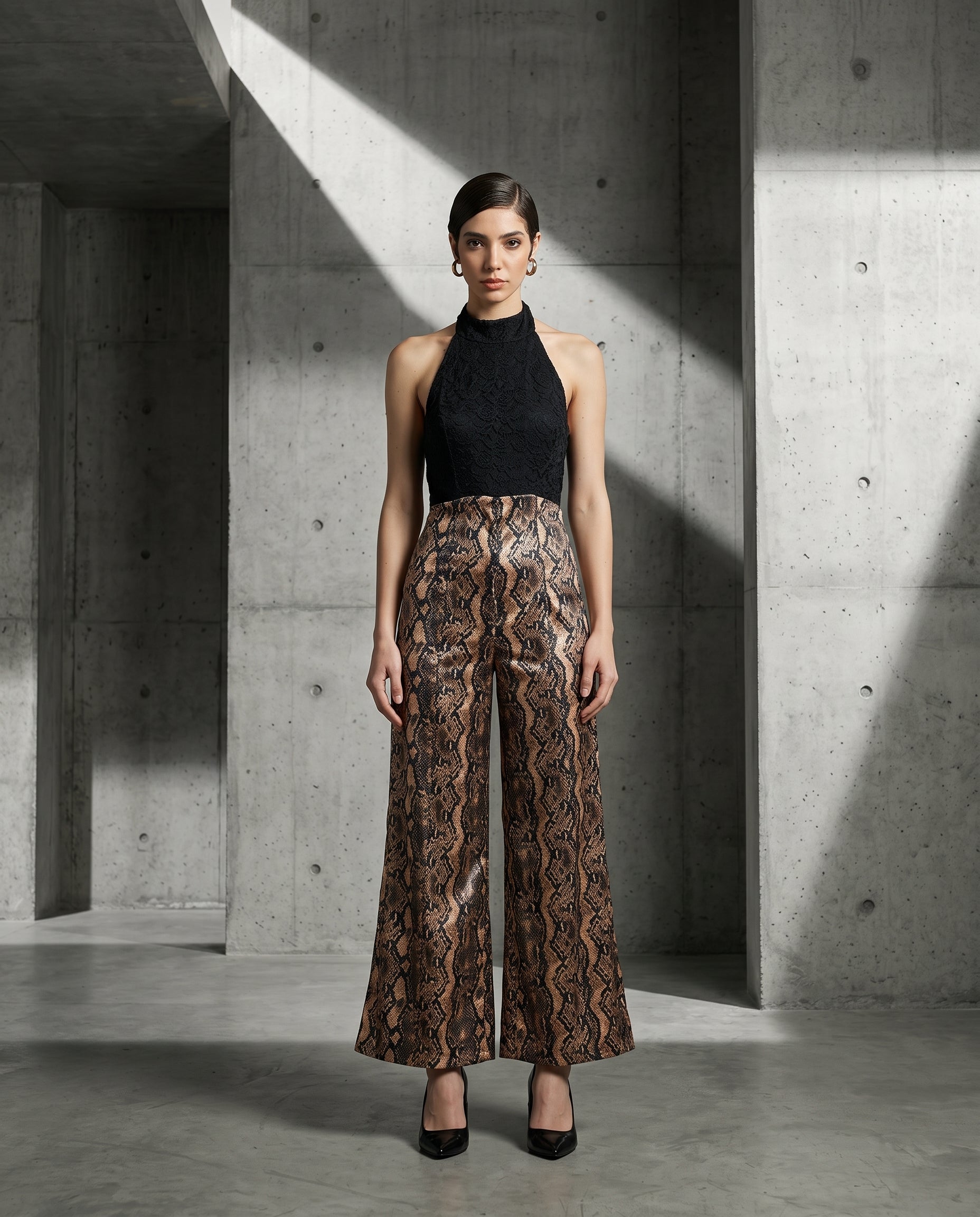 Viper halter wide-leg jumpsuit in black and gold metallic snakeskin, front view — INHAUTECOUTURE